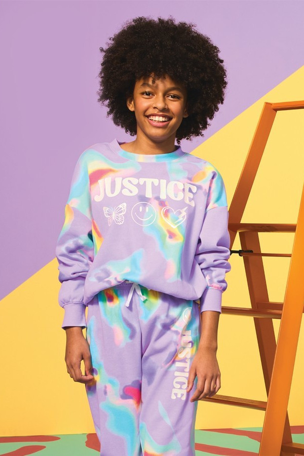 A lifestyle shot of a model wearing Justice apparel.