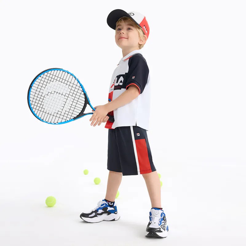 A lifestyle shot of a model wearing FILA apparel.