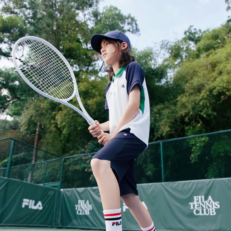 A lifestyle shot of a model wearing FILA apparel.